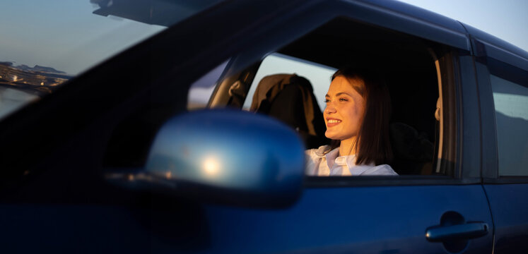 positive woman driver driving a car