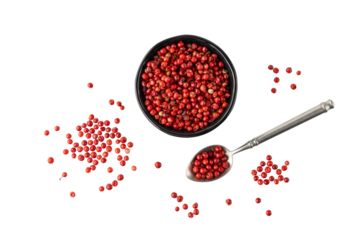 Pink peppercorn  pepperberry  in black bowl and on retro spoon isolated on white background. Aromatic spicy ingredient for cuisine.