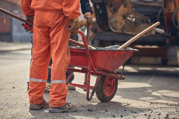 Construction workers working on a public city street reconstruction.