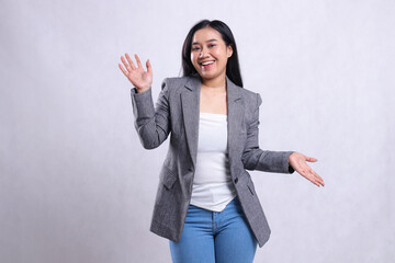 expression of cheerful beautiful young woman asia raising both palms up and down wearing grey suit and jeans standing isolated on white background. for advertising content, fashion, banner, magazine