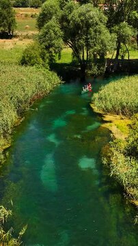 In canoa risalendo il fiume Tirino in Abruzzo, Italia.
Vista aerea dei canoisti che remano risalendo la corrente del fiume. Ripresa Verticale.