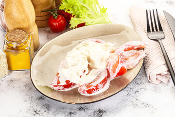 Salad with sliced tomato and stracciatella