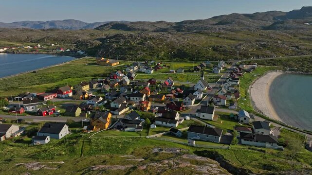 Aerial tracking shot in front of the Bugoynes village, summer in Finmark, Norway