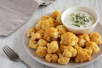 Homemade Buffalo Cauliflower with Blue Cheese Sauce, side view.