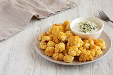 Homemade Buffalo Cauliflower with Blue Cheese Sauce, side view.