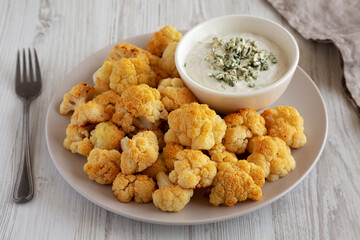Homemade Buffalo Cauliflower with Blue Cheese Sauce, side view.