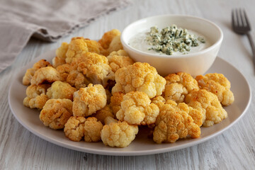 Homemade Buffalo Cauliflower with Blue Cheese Sauce, side view.