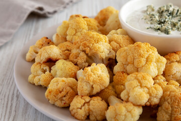 Homemade Buffalo Cauliflower with Blue Cheese Sauce, side view. Close-up.