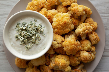 Homemade Buffalo Cauliflower with Blue Cheese Sauce, top view. Close-up.