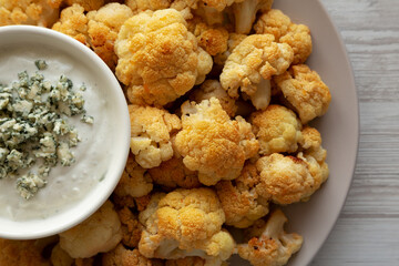 Homemade Buffalo Cauliflower with Blue Cheese Sauce, top view. Close-up.