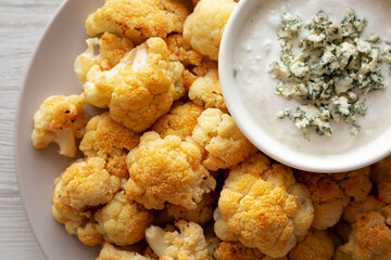 Homemade Buffalo Cauliflower with Blue Cheese Sauce, top view. Close-up.