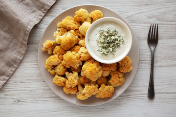 Homemade Buffalo Cauliflower with Blue Cheese Sauce, top view.