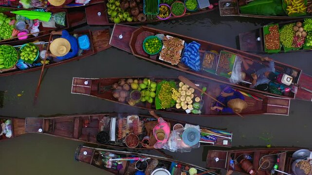 Aerial view Damnoen Saduak floating market, Farmer go to sell organic product, fruit, vegetable and Thai cuisine, Tourist visiting by boat, Ratchaburi, Thailand, Famous floating market in Thailand.