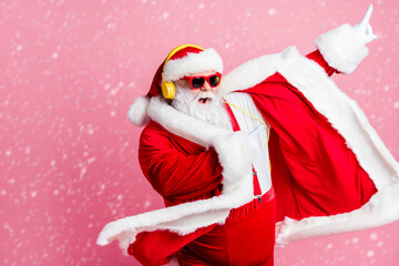 Photo crazy funky cool bearded santa claus enjoy listen headphone stereo x-mas christmas music dance raise finger wear sunglass headwear suspenders isolated pastel color background