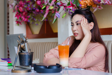 expression of beautiful young woman looking in front of her arms holding her head in pain,...