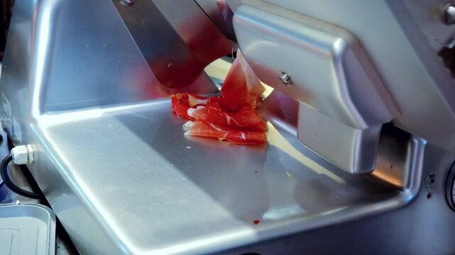 Authentic Italian food making process in traditional Italian restaurant, of smoked ham Coppa being sliced and prepared