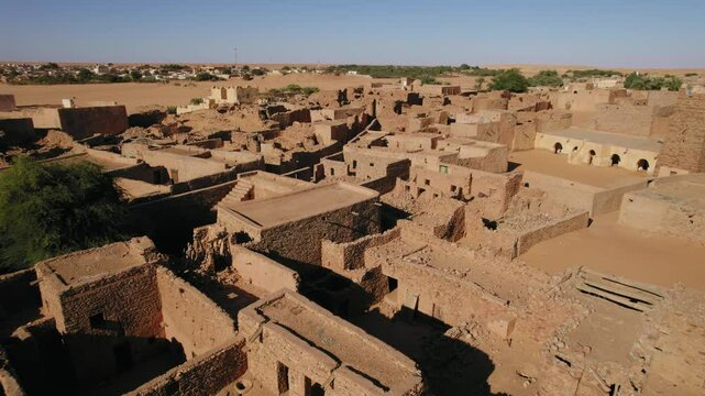 Drone flying over ancient ruins of Chinguetti, desert of Mauritania. Aerial forward