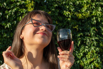 Young attractive woman drinking red wine	