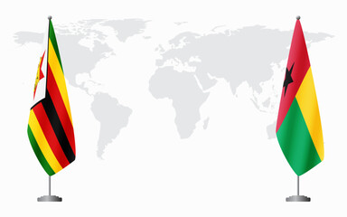 Zimbabwe and Guinea Bissau flags for official meeting against background of world map.