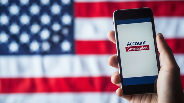 Account Suspended Notification on Smartphone Displayed Against Blurred American Flag Background - Powered by Adobe