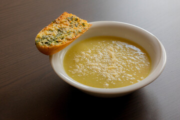 Zucchini Cream Soup with Parmesan and Garlic Bread Close-Up on Dark Background