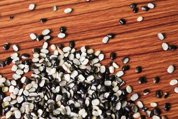 Split Black Lentil Also Know as Black Gram, Black Urad Dal, Vigna Mungo, Urad Bean on brown wooden...
