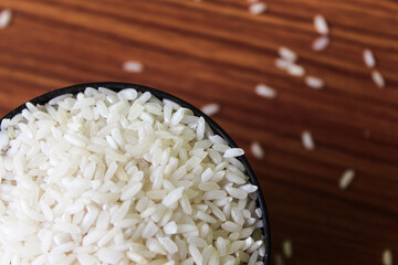 White rice bowl in wood isolated, Concept of Water-Conserving Products. Saving water. Horizontal orientation. Raw basmati rice on  wooden
