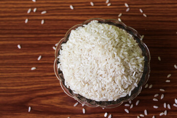 White rice bowl in wood isolated, Concept of Water-Conserving Products. Saving water. Horizontal orientation. Raw basmati rice on  wooden
