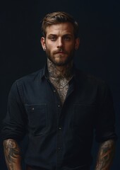 Fototapeta premium A man with a beard and tattoos stands in front of a black background