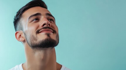 Fototapeta premium A man with a beard and mustache is smiling and looking up at the sky