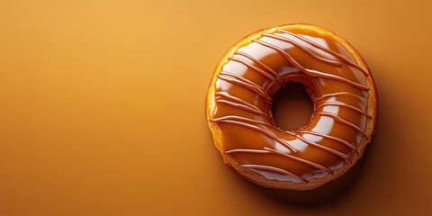 A delicious glazed donut drizzled with caramel, set against a warm orange background, perfect for dessert lovers, background with copy space