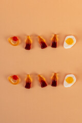 Egg jelly candy and jelly bears candy and Cola flavored gummy jellies isolated on the cream background