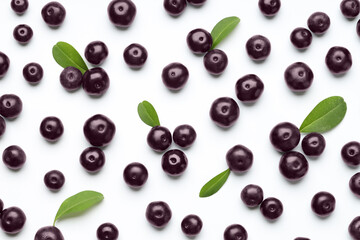 Ripe acai berries and leaves on white background, flat lay