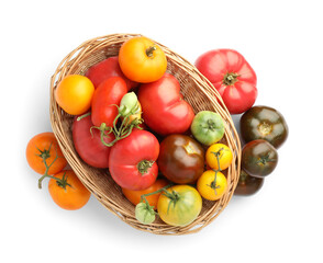 Different ripe tomatoes in basket isolated on white, top view