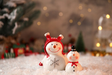 Funny snowmen figures on artificial snow, closeup