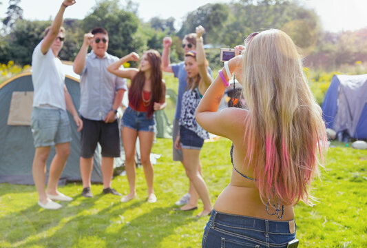Back View of Woman Taking a Photograph of Group of Teenagers
