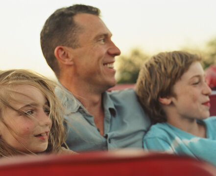 Portrait of Man and Children Smiling
