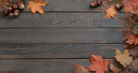 Obraz premium Beautiful autumn leaves and acorns arranged on a rustic wooden background in warm colors
