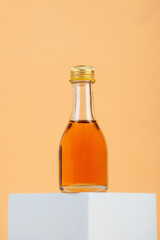 Glass jar with sweet honey isolated on cream background