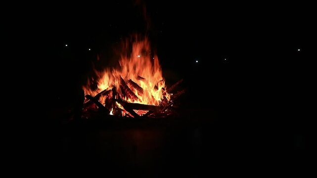 View loop of burning firewoods, bright firecamp with sparks at night, Camp fire in the night. Exploring the wildness travelling in outdoor
