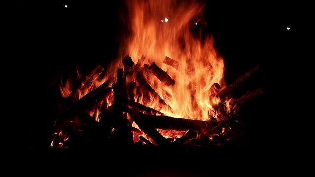 View loop of burning firewoods, bright firecamp with sparks at night, Camp fire in the night. Exploring the wildness travelling in outdoor