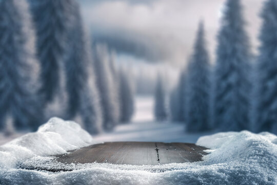 Fototapeta Empty wooden table top coverd with snow with copy space and winter snowing trees and mountain background.