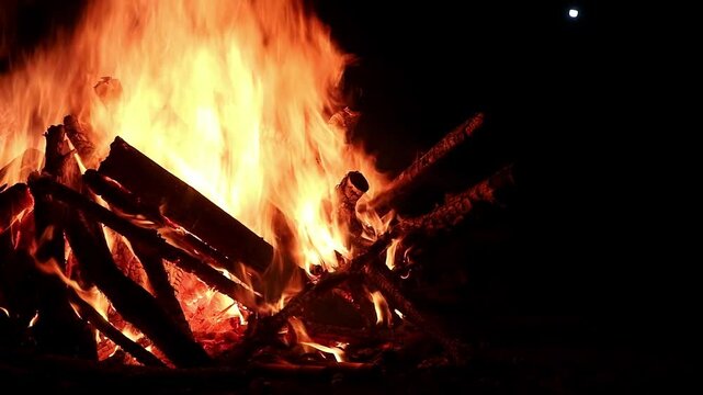 View loop of burning firewoods, bright firecamp with sparks at night, Camp fire in the night. Exploring the wildness travelling in outdoor