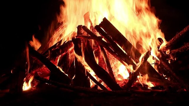 View loop of burning firewoods, bright firecamp with sparks at night, Camp fire in the night. Exploring the wildness travelling in outdoor