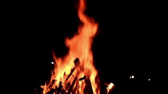 View loop of burning firewoods, bright firecamp with sparks at night, Camp fire in the night. Exploring the wildness travelling in outdoor