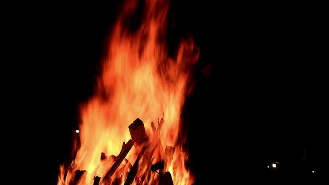 View loop of burning firewoods, bright firecamp with sparks at night, Camp fire in the night. Exploring the wildness travelling in outdoor