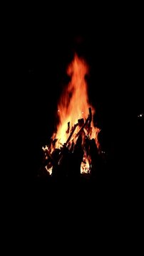 View loop of burning firewoods, bright firecamp with sparks at night, Camp fire in the night. Exploring the wildness travelling in outdoor