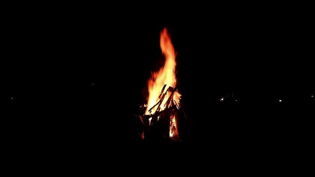 View loop of burning firewoods, bright firecamp with sparks at night, Camp fire in the night. Exploring the wildness travelling in outdoor