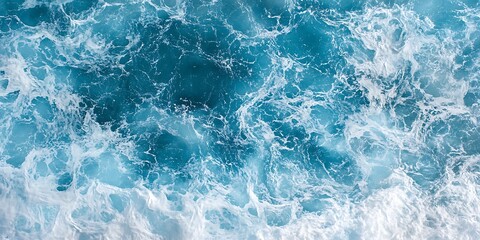 Fototapeta premium Aerial view of vibrant ocean waves and foam.