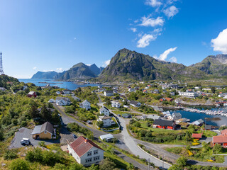 Aerial view, villagescape of Sorvagen in middle of rugged landscape. Lofoten district in Norway